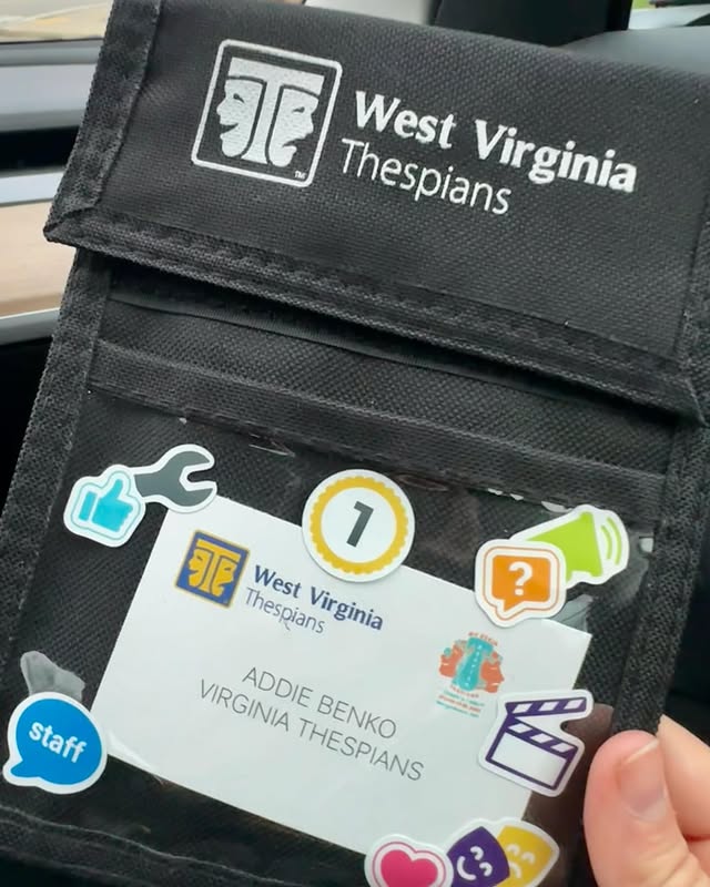 A finished conference badge with stickers applied